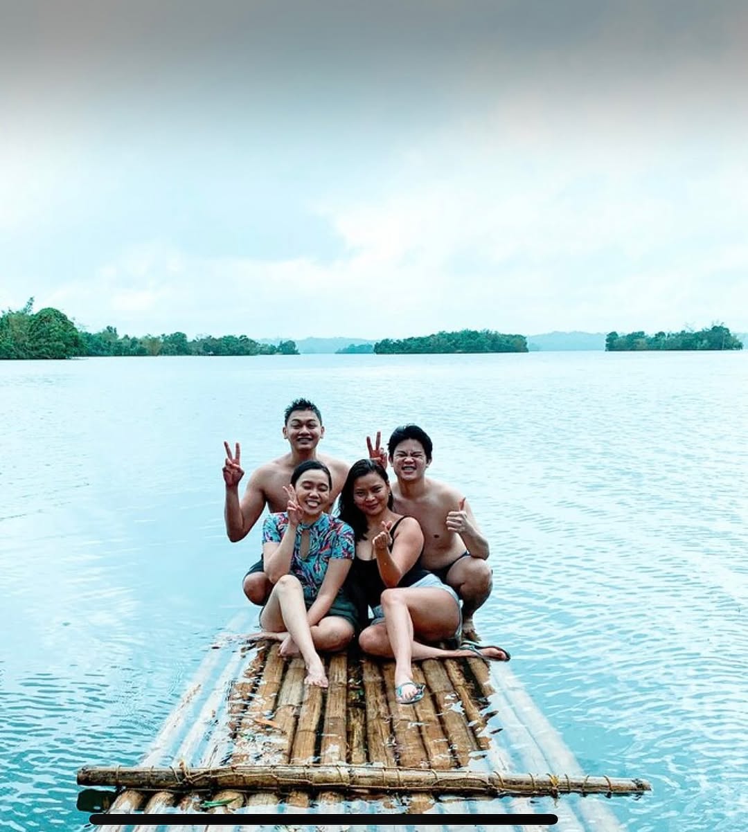Group of guests on the bamboo raft platform on the lake