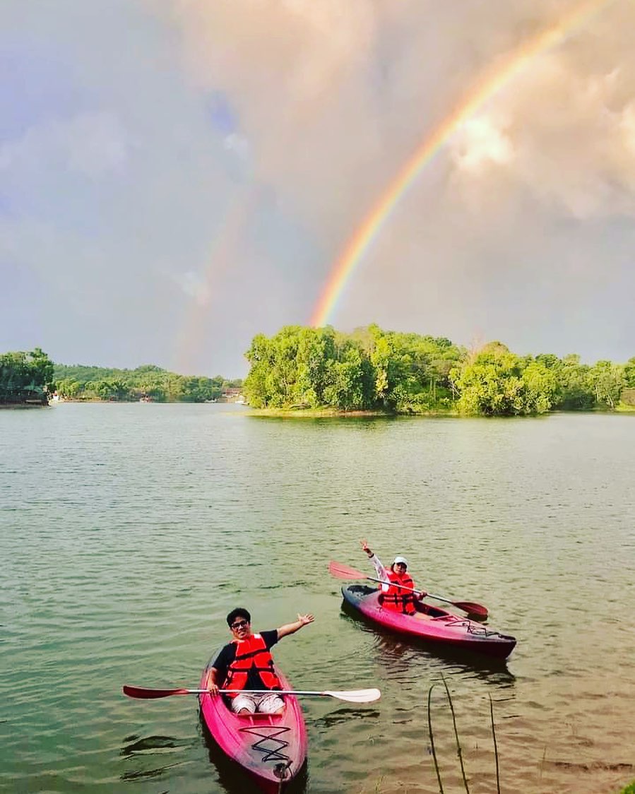 Kayaking on Lake Lumot with rainbow overhead